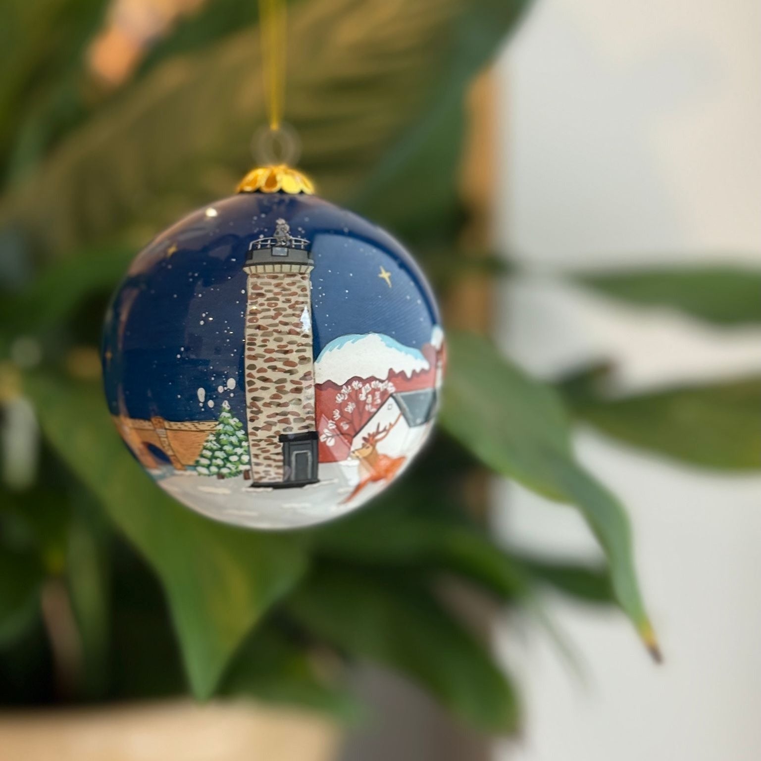 Hand-painted Scottish Christmas decoration bauble with lighthouse and winter scene