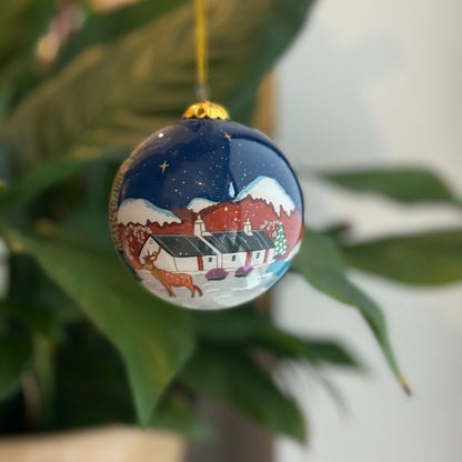 Glossy blue Scottish Christmas decoration bauble with hand-painted winter scene